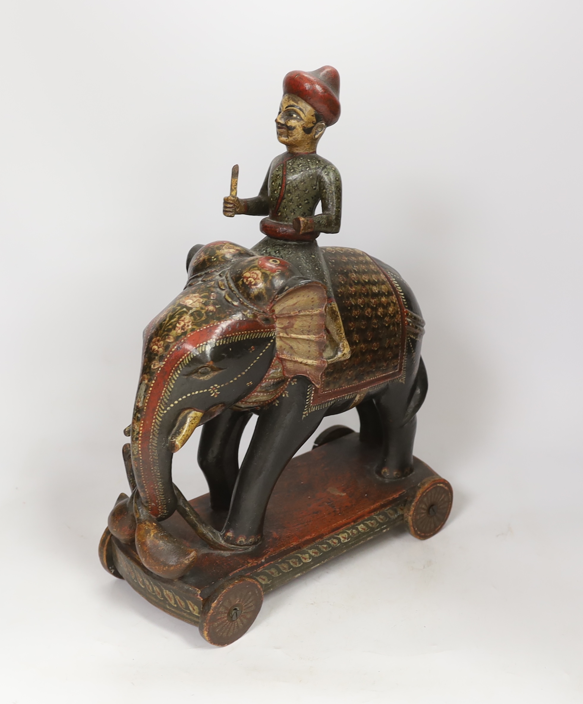 A Rajasthan painted wood elephant and rider pull-along toy, 38cm